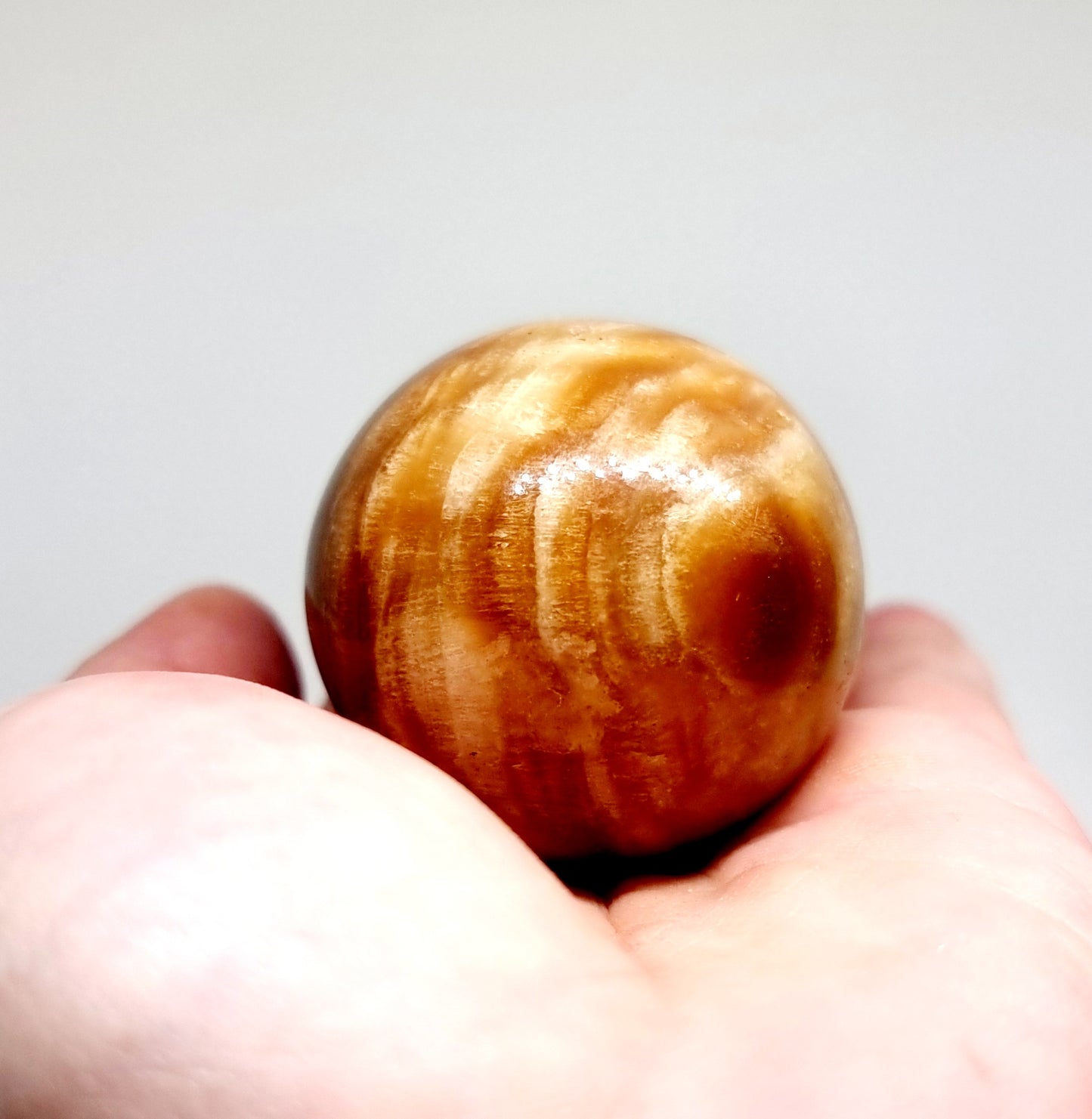 POLISHED CARAMEL SWIRL ARAGONITE SPHERE 129 g - PATIENCE